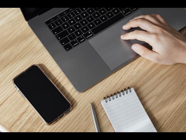 Person's hand using a laptop